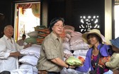 霞漳會館理事長何天輝向貧困戶發送大米。