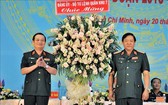 第七軍區政委陳懷忠海軍上將（左）代表第七軍區政委向市司令部贈送鮮花表示祝賀。（圖源：越通社）