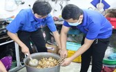 志願青年烹煮飯菜並贈送給貧困者。