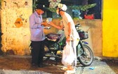 “愛心之家”慈善組向貧困者派發抗菌洗手液及醫用口罩。