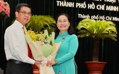 市人民議會主席阮氏麗（右）向阮文勇同志（左）贈送鮮花表示祝賀。