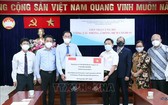 本市印尼商會和印尼人共同體代表象徵性向市越南祖國陣線委員會轉交捐贈的款項和必需品。（圖源：越通社）