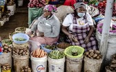 女攤販在肯尼亞一家市場賣蔬菜。（圖源：聯合國）