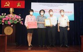 市越南祖國陣線委員會主席蘇氏碧珠接收物資。