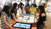 Visitors are excited with interactive touchscreen. Museums apply digital technologies to attract visitors (Photo: SGGP)