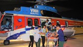 Lực lượng nhân viên y tế và nhân viên sân bay vận chuyển bệnh nhân từ trực thăng về bệnh viện