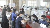 Làm hồ sơ thuế tại Cục Thuế TPHCM. Ảnh: CAO THĂNG