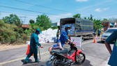 Lực lượng chức năng xã An Bình, huyện Phú Giáo phun thuốc khử khuẩn phương tiện ở ấp Cà Na. Ảnh chụp tháng 2-2021