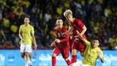 Vietnam's team (in red jersey) in a recent international event. They will face Thailand on September 5 in the Asian zone’s second qualifying round for the World Cup 2020. (Photo: nld.vn)