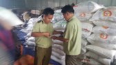Inspectors check a warehouse of sugar (Photo: SGGP)