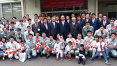 President Tran Dai Quang took a picture with leaders of Koganei Seiki Co. Ltd. and Vietnamese engineers working here. Photo by Tran Luu