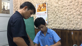 Phan Minh Thong is patiently teaching his students in the Binh Thanh School of Hope for Hearing-impaired People