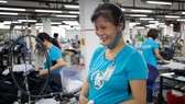 Tinh Nguyen, a seamstress for Maxport Limited Vietnam works on an assembly line in its Hanoi factory. Photo courtesy of IFC