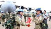 Two members of the level-2 field hospital folded the military flag before the departure of the peacekeeping force in October 2018. (Photo: VNA)