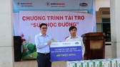 Ông Vũ Quang Sáng, Chủ tịch Công đoàn EVNGENCO3 (ảnh trái) trao biểu trưng tài trợ cho Trường Tiểu học Vĩnh Tiến.