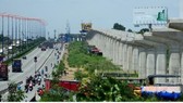 The pillars on the right of the photo is the under construction above ground stretch of the first metro line Ben Thanh-Suoi Tien in HCMC (Photo: SGGP)