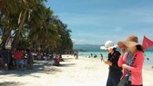 Tourists on a Philippine beach (Source: https://www.pna.gov.ph)