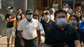People wear face masks to avoid COVID-19 infection in Kuala Lumpur, Malaysia, on March 14 (Photo: Xinhua/VNA)