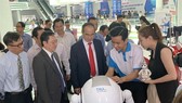 HCMC leaders look at AI products displayed at an exhibition held on the "Day for AI and IT Enterprises" event recently in HCMC. (Photo: VNA/VNS)