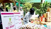 Chọn mua nhu yếu phẩm tại điểm bán dã chiến do Công ty TNHH Aeon Việt Nam tổ chức.  Ảnh: NGỌC HIỂN