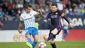 Messi (phải) và đồng đội không khó để giành chiến thắng trước Malaga. Ảnh: Getty Images