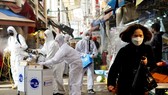 Các nhân viên khử trùng một khu chợ truyền thống ở thủ đô Seoul, Hàn Quốc. Ảnh: REUTERS 