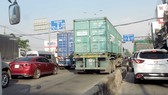 Lưu lượng ô tô lưu thông trên quốc lộ 22 ngày một quá tải, tạo áp lực căng thẳng cho lái xe tải hạng nặng - nhất là xe container. Ảnh: VĂN PHONG