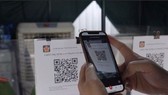A QR code on a chip-based citizen ID card displays 7 essential information fields.