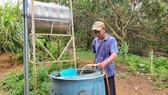 Vy Van Tuyen is taking clean water from the supply station sited at Ia Muung Hamlet