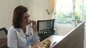 Bác sĩ Phan Thị Thanh Thủy đang tư vấn cho một người dân về cách phòng chống Covid-19 tại bàn trực
