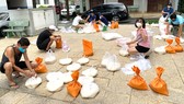 Nhóm tự nguyện của chung cư Him Lam Nam Sài Gòn chia gạo để cứu trợ cho xóm trọ kế bên chung cư