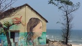 A portrait of a girl is painted on the wall of a house in Tam Thanh village in Quang Nam (Photo: VNA)