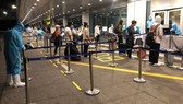 Passengers get health check at Van Don International Airport.
