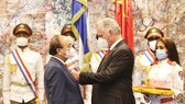 Cuban President Miguel Díaz-Canel Bermúdez presents President Nguyen Xuan Phuc with the José Martí Order in recognition of the Vietnamese leader’s contributions to the enhancement of the historical friendship, solidarity and cooperation between Cuba and V
