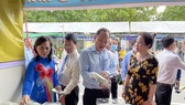 Vice Secretary of the HCMC Party Committee Nguyen Ho Hai  (C) visits a display booth at the exhibition.