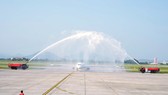 Myanmar Airways International (MAI)'s first flight is welcomed with a water canon salute as it lands at Noi Bai Airport.