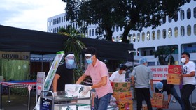 Tiếp tế nhu yếu phẩm tại Bệnh viện Bệnh nhiệt đới. Ảnh: PHÚ KHÁNH