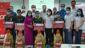 Bà Trần Thị Quỳnh Châu - Phó Giám đốc Agribank Bình Dương (thứ tư hàng đầu từ bên phải) tặng quà và sổ tiết kiệm cho công nhân có hoàn cảnh đặc biệt khó khăn của công ty TBS group