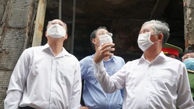 Đồng chí Ngô Minh Châu (phải) trực tiếp chỉ đạo tại hiện trường vụ cháy ở quận 11, TPHCM