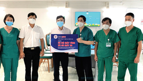 Ông Lê Xuân Thái - Chủ tịch Công đoàn EVNSPC (thứ ba từ trái sang) trao tặng 50 bộ máy tính và 50 máy in cho Bệnh viện Bạch Mai tại TPHCM