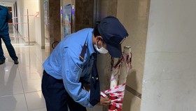 Bảo vệ chung cư tháo hàng rào barie và bảng thông báo cách ly tại tầng 15 chung cư Carillon. Ảnh: Báo Lao động