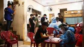 Điều tra dịch tễ, lấy mẫu xét nghiệm COVID-19 cho nhân viên quán nướng ngói Bảo Lộc, 160 Phạm Văn Đồng, quận Gò Vấp vì bệnh nhân tái dương tính ở quận 3 từng đến đây lúc 18h45 đến 20h30 ngày 4-5 - Ảnh: NHẬT THỊNH