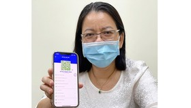 Deputy Director of the HCMC Department of Information and Communication Vo Thi Trung Trinh with her individual QR code on ‘Y te HCM’ app.