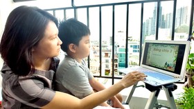 Mẹ kèm con học online tại nhà. Ảnh: DŨNG PHƯƠNG