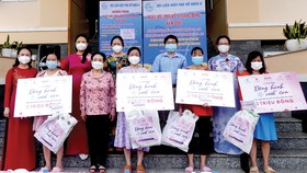 PGS-TS Trương Thị Hiền, Chủ tịch Hội nữ Trí thức TPHCM cùng đại diện Hội Liên hiệp Phụ nữ TPHCM, Báo SGGP trao quà cho các thai phụ. Ảnh: VIỆT NGA