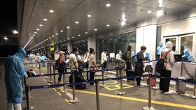 Passengers get health checks at Van Don International Airport.