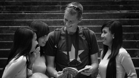 Friendly smiles of Vietnamese people and foreign visitors in HCMC (2011)