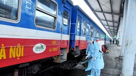 Health workers are cleaning and disinfecting a train.