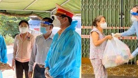 Vice secretaries of the municipal Party Committee, Nguyen Thi Le (L) and Nguyen Ho Hai visit people and the security forces in the blocked sites and bule zones in Cu Chi and Tan Binh districts amid restrictions on social distance. (Photo: SGGP) 