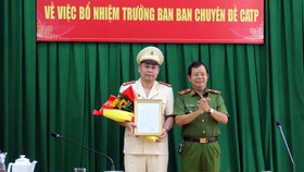 Thiếu tướng Trần Đức Tài, Phó Giám đốc Công an TPHCM trao quyết định, tặng hoa chúc mừng Đại tá Bùi Ngọc Giáp